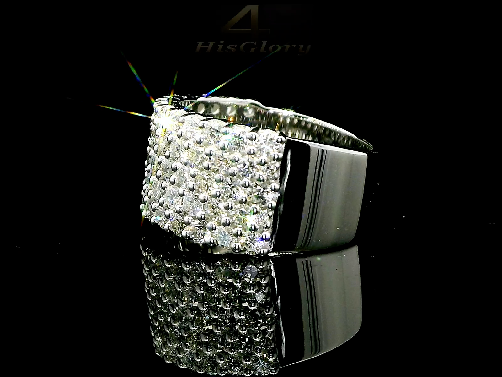 Close-up image of a white gold ring encrusted with multiple small diamonds, reflecting light on a black surface. The ring features a pattern of closely set diamonds creating a sparkling effect.
