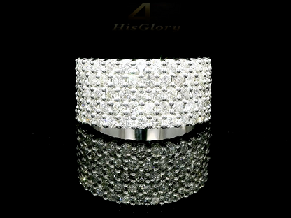 Close-up image of a white gold ring encrusted with multiple small diamonds, reflecting light on a black surface. The ring features a pattern of closely set diamonds creating a sparkling effect.