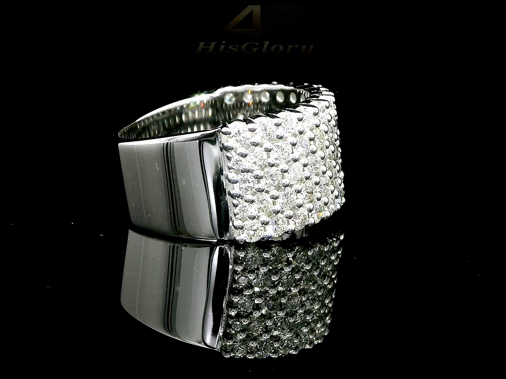 Close-up image of a white gold ring encrusted with multiple small diamonds, reflecting light on a black surface. The ring features a pattern of closely set diamonds creating a sparkling effect.