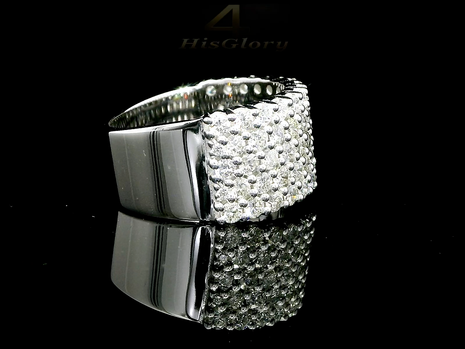 Close-up image of a white gold ring encrusted with multiple small diamonds, reflecting light on a black surface. The ring features a pattern of closely set diamonds creating a sparkling effect.